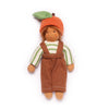 Toy figure wearing a striped shirt, brown overalls, and an apple hat on a white background